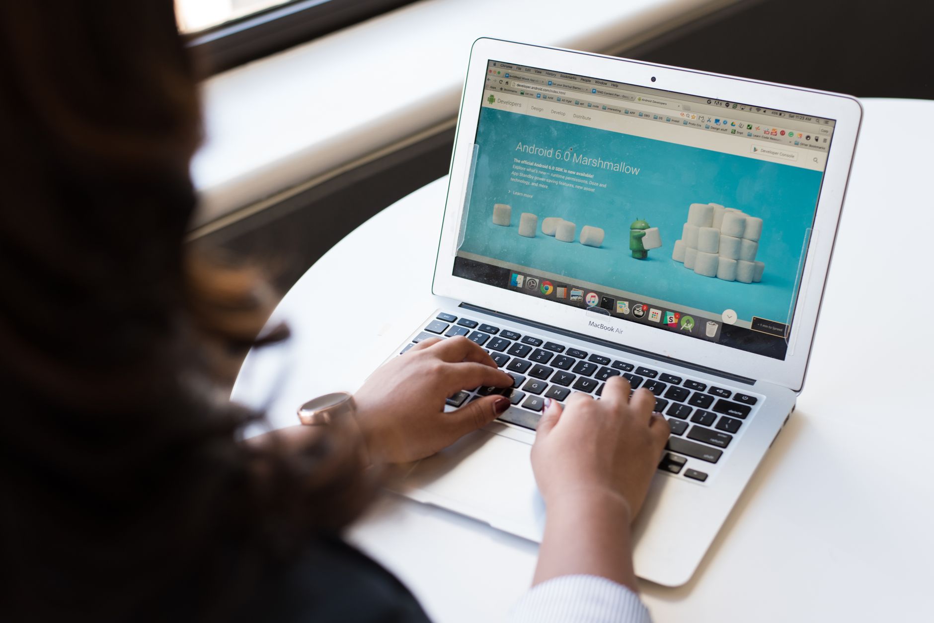 A laptop screen showing a website redesign in progress, side by side with the original layout